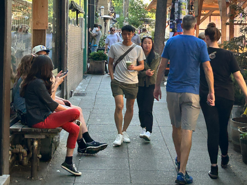 People walking down the sidewalk on Ballard Ave