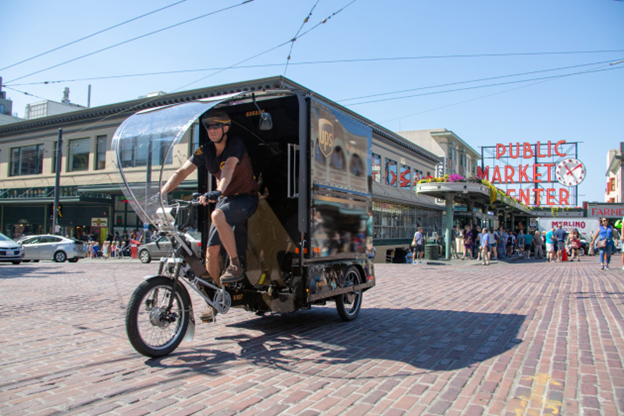 E-cargo bike traveling in front of Pike Place Market