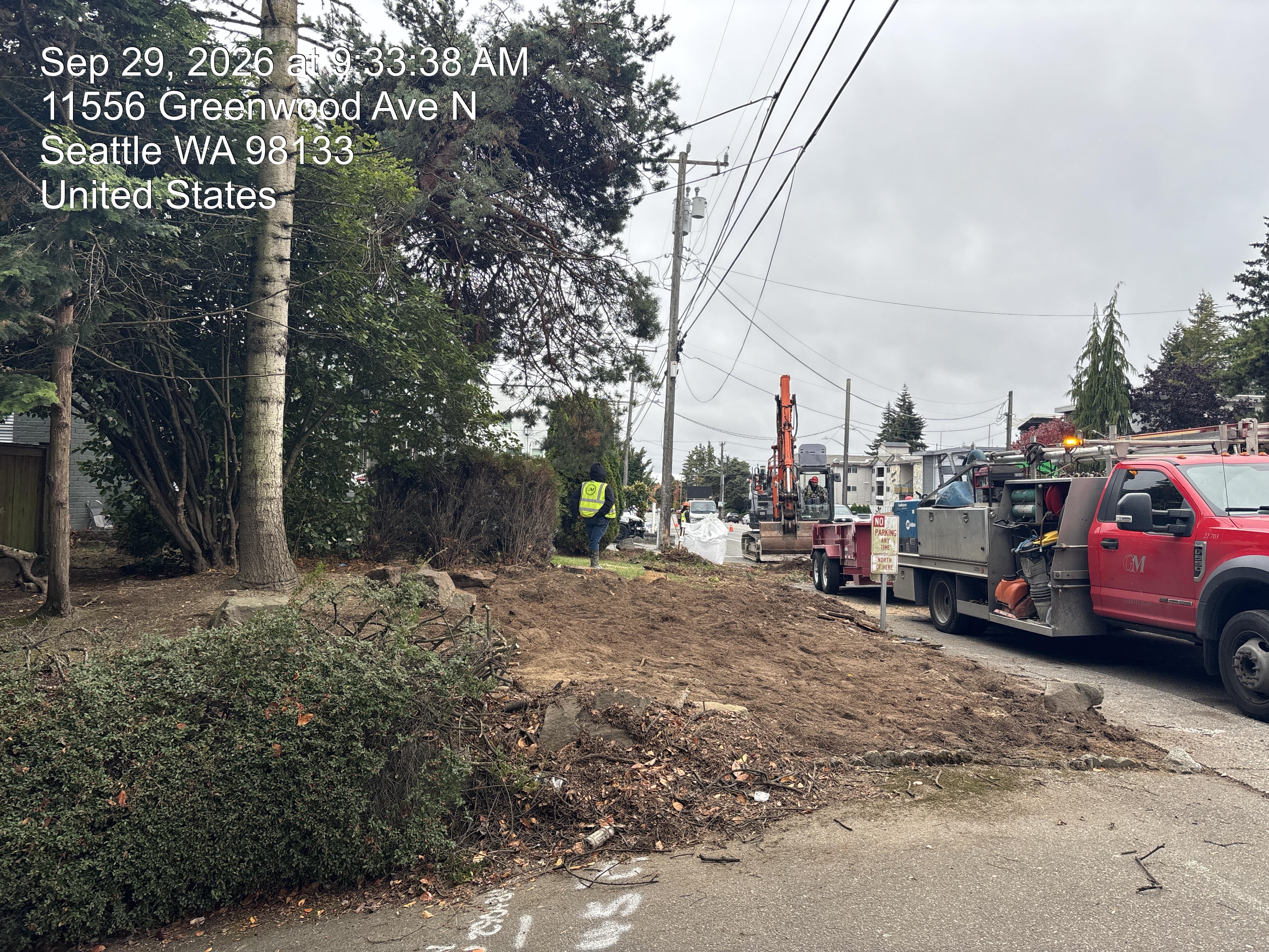 Workers clearing and preparing the roadside for construction