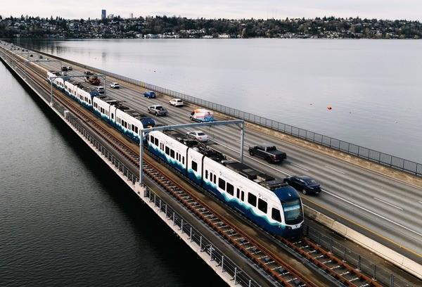 Sound Transit light rail train travels across Lake Washington on an overcast day.