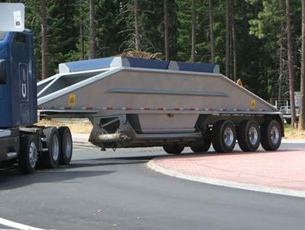 Photo of semi truck driving through roundabout