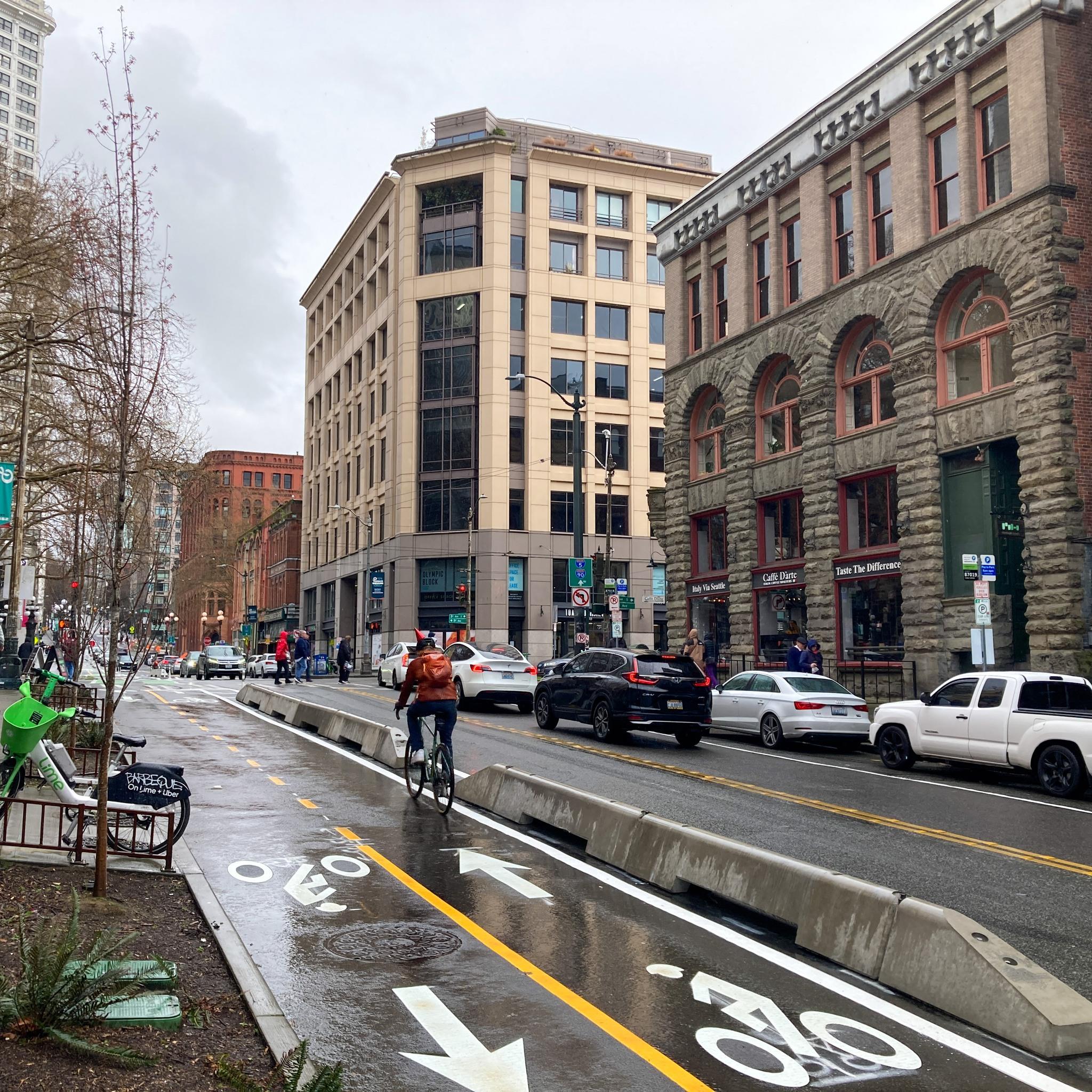 Photo showing an example of concrete curbs separate the bike lane from moving cars.