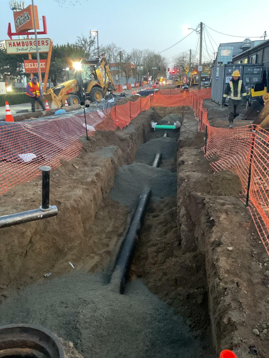 A trench dug on 30th Ave NE for SPU to access watermain.