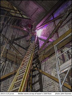 Welder works at the top of the 10th floor tower