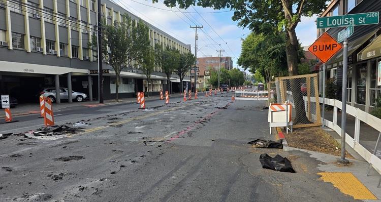 The image shows the street surface along Eastlake Ave E being made ready for demolition