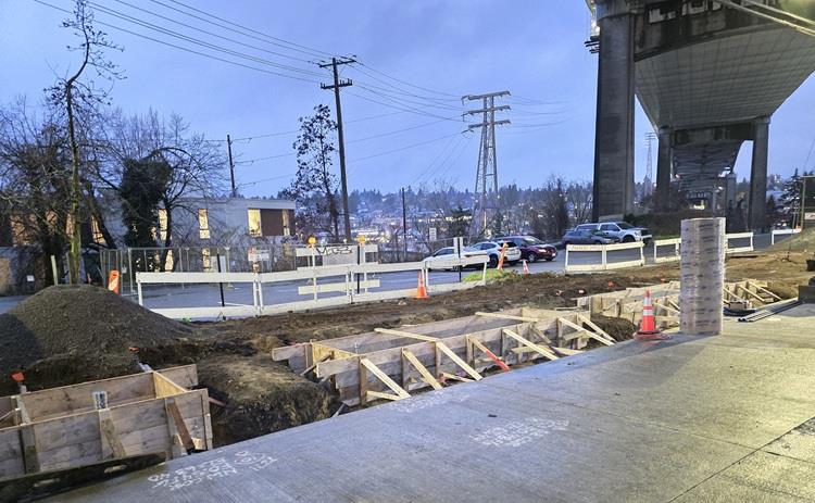 Image shows the pouring of concrete at the intersection of Eastlake Ave E and Yale Pl NE