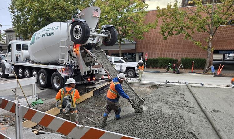Image shows our team pouring concrete to create the new street along Eastlake Ave E between E Lynn St and E Louisa St. 