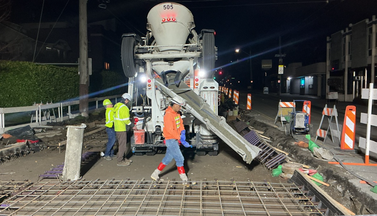 Image shows the team pouring concrete on Eastlake Ave E