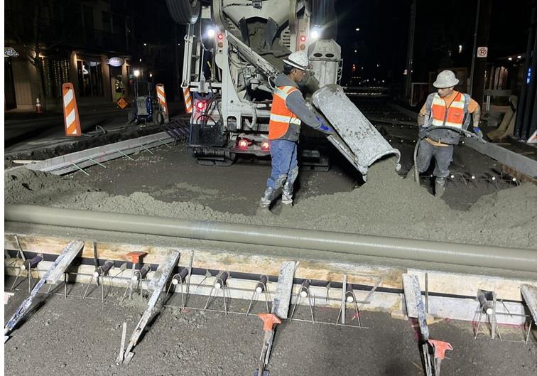 Image shows the team pouring new concrete on Eastlake Ave E