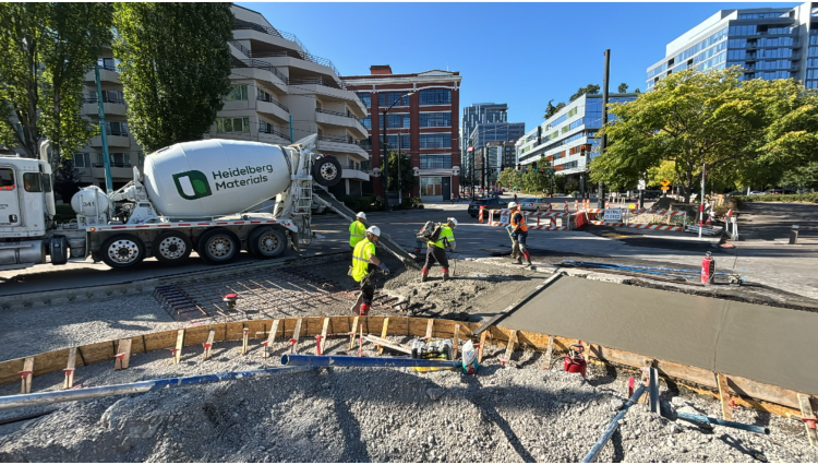 Image shows crews pouring new concrete on Fairview Ave N.