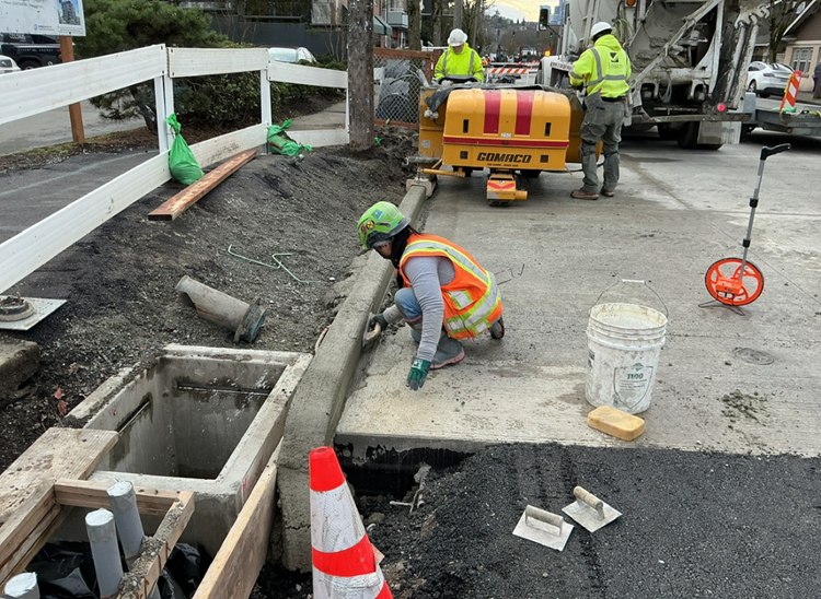 Image shows the team pouring new concrete curbs on Eastlake Ave E