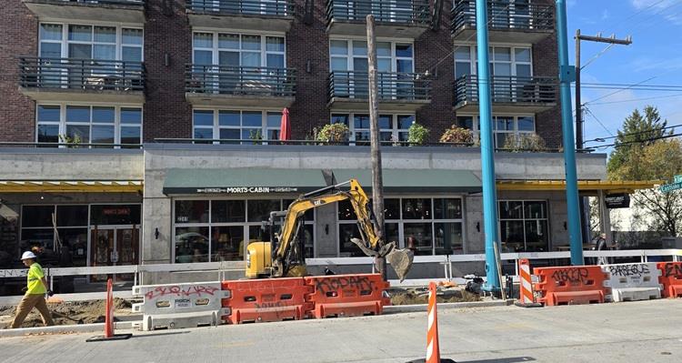 Image shows the team building a new bus station and pouring new street panels near E Lynn St. 