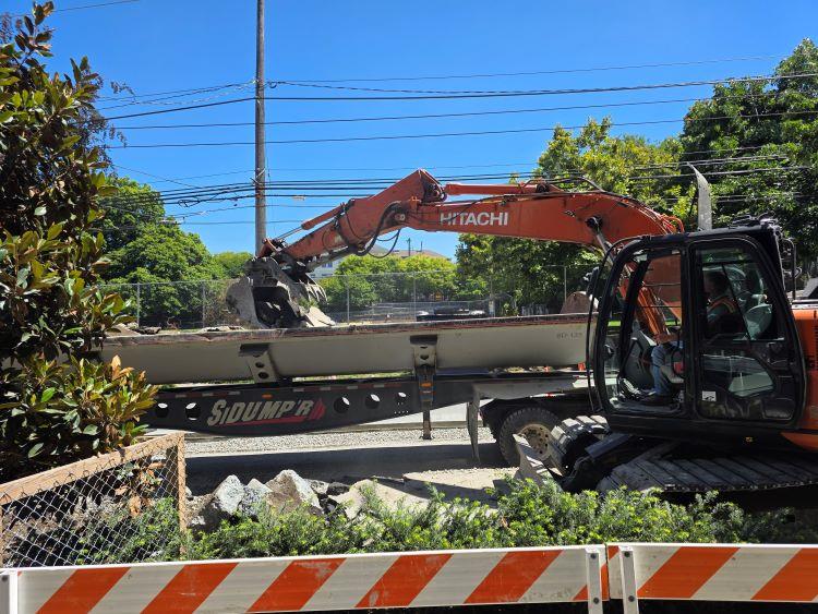 Image shows construction machinery being used to remove concrete debris.&nbsp;