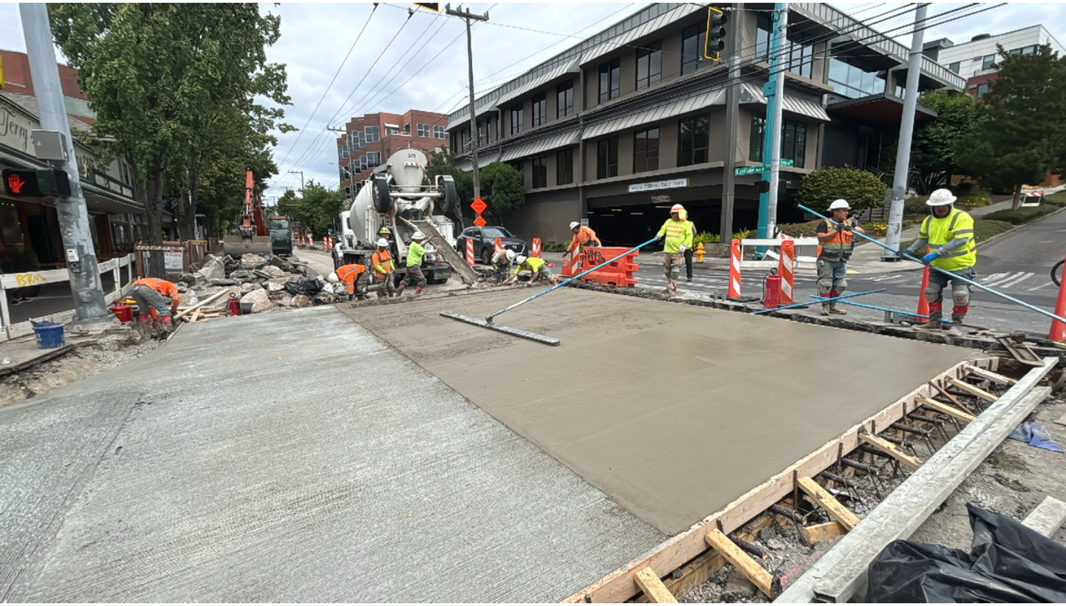 Image shows crews smoothing out new concrete at Eastlake Ave E and E Lynn St.
