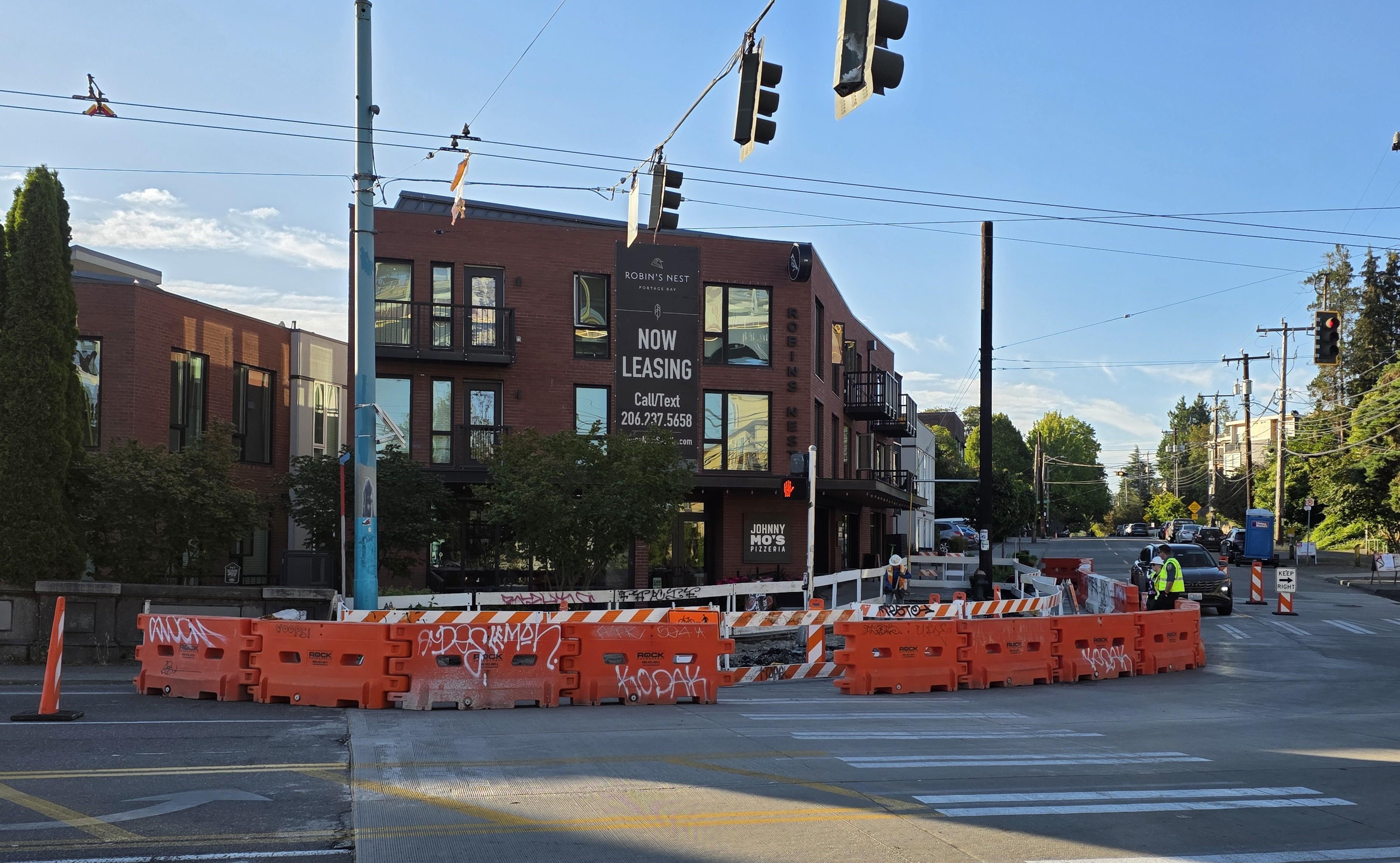 Image shows a temporary construction barrier directing people around traffic near construction at Eastlake Ave E and Fuhrman Ave E