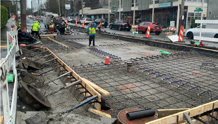 Image shows the team placing new concrete street panels on Eastlake Ave E 