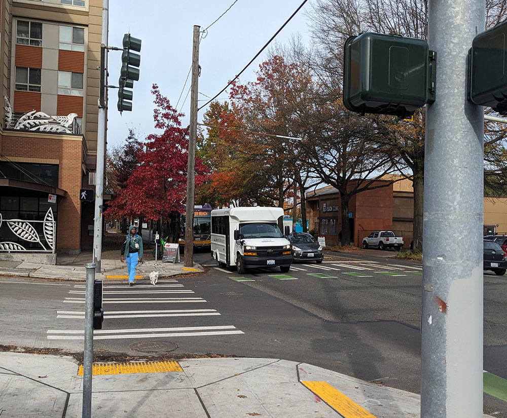 Person waiting to cross at the improved Walden and Rainier intersection