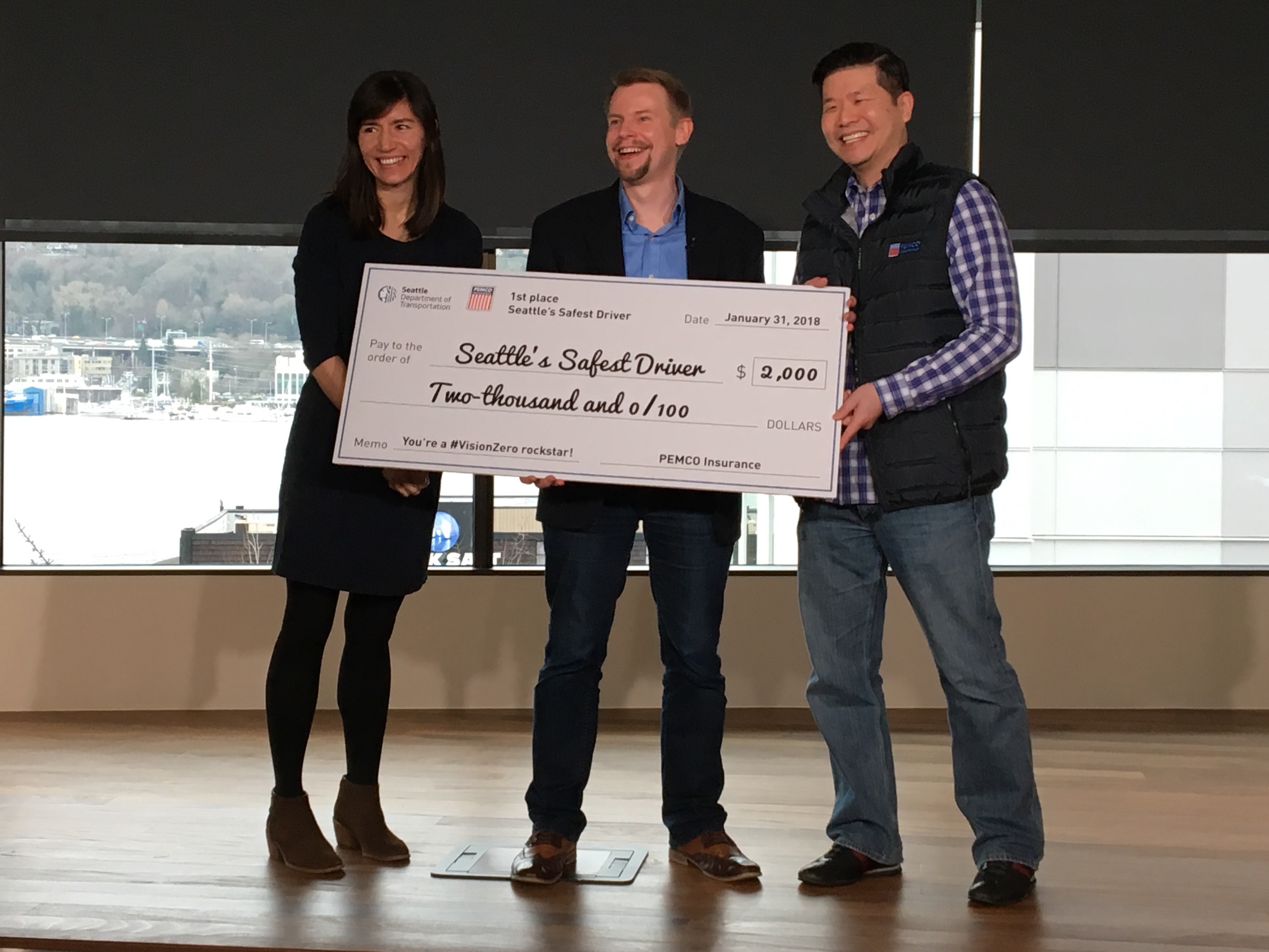 SDOT and PEMCO hand off a giant check to Russell Lebert, Seattle’s Safest Driver