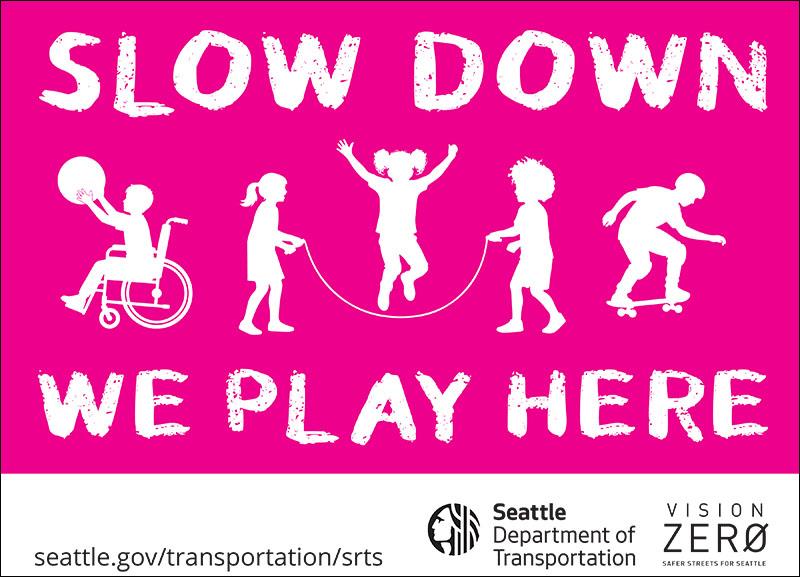 Pink sign with children that says slow down we play here
