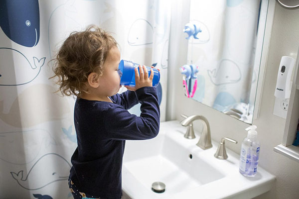 small child drinking water