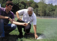 Photo of 2 men testing irrigation