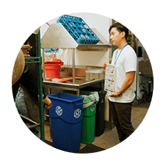 SPU employee demonstrating compost bin.