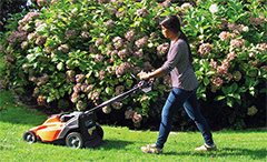 Photo of woman mowing lawn