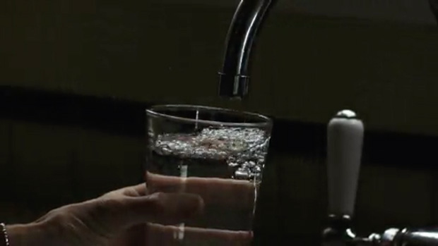 Photo of a glass under a water faucet