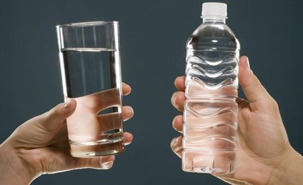 Photo of a water glass and bottle