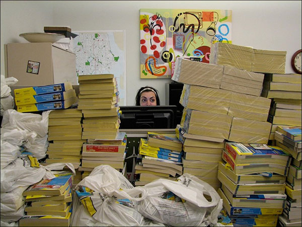 Room with piles of phone books