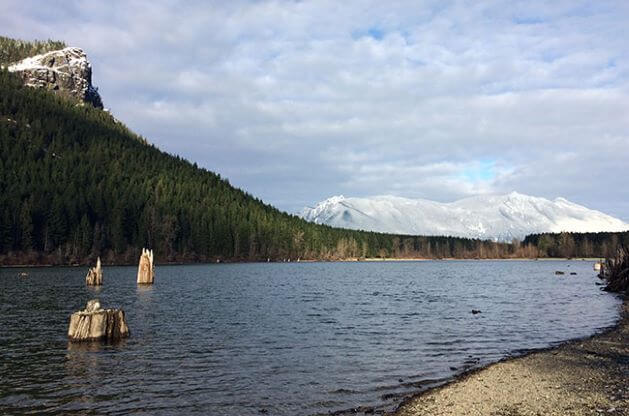 Photo of Rattlesnake Lake and Ledge on a calm day with broken cloud cover.