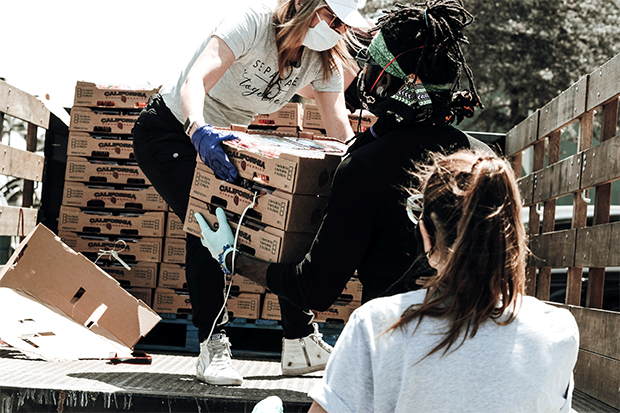 People loading fruit onto truck