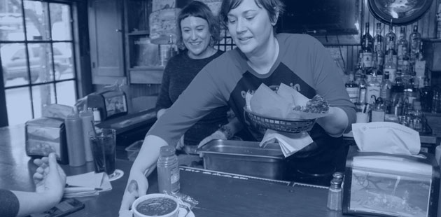 Server at Loretta's Northwesterner serving soup to a customer at the bar