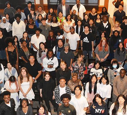 A large group of diverse Seattle youth looks up at the camera