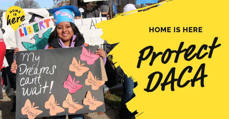 A DACA-recipient wearing a graduation cap outside at a protest holding a sign that reads: "My Dreams can't wait!" To the right of her is a yellow splotch with the words: "HOME IS HERE, Protect DACA."