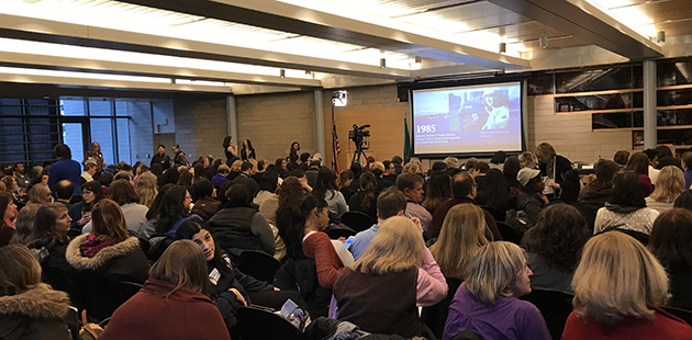 Seattle Women's Commission event, 2018. A room of people learning about the history of women in Seattle. 