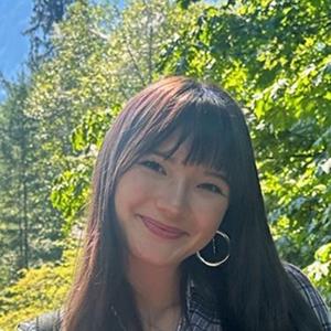 Picture of Audrey smiling with trees in the background