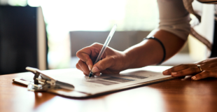 A person filling out a paper form.
