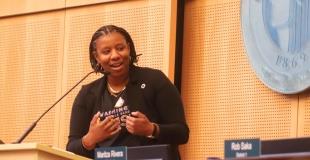 Council President Hollingsworth speaking into a podium mic at City Hall Chambers