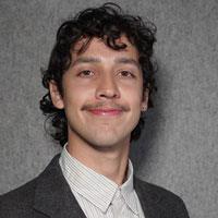 Matt has a mustache and longish, wavy hair.