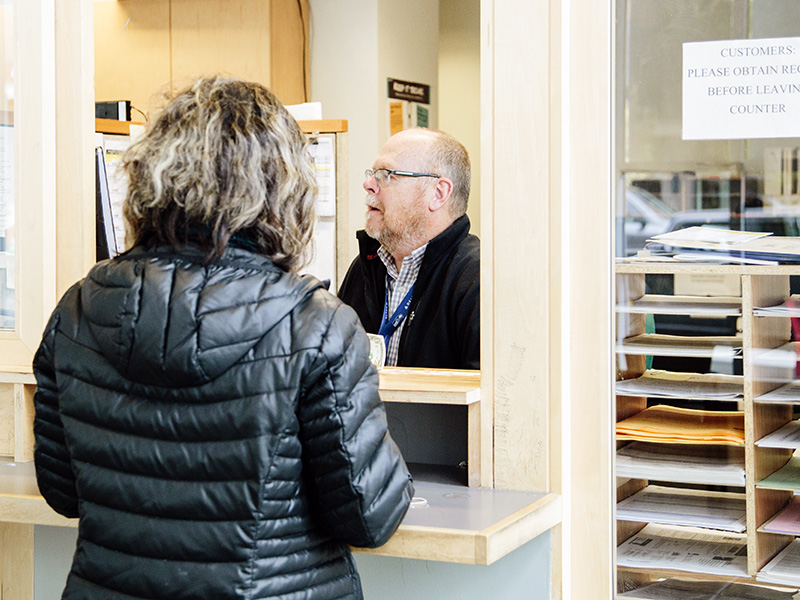 Staff member helping a customer at Ballard Customer Service Center