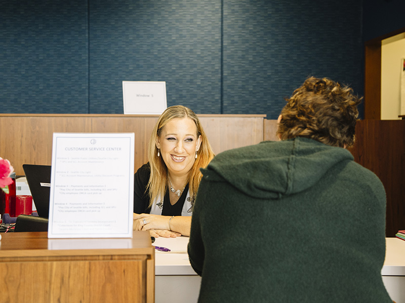 Staff member helping a customer at the Downtown Customer Service Center
