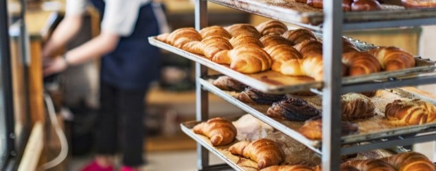 Bakery kitchen stocked with baked goods.
