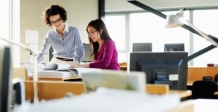 Employees working together at a desk photo