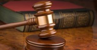 Image of a wooden gavel resting on a gavel pad
