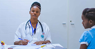 A nurse prepares paperwork for a child