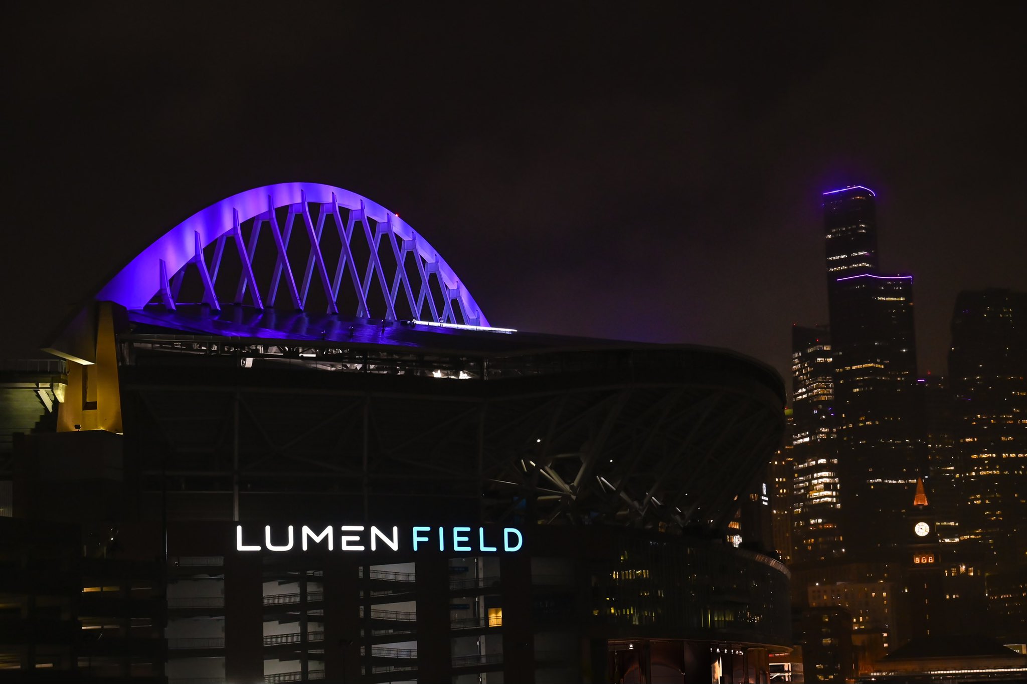 Lumen Field lit up in purple for Domestic Violence Awareness Month; and so did the Columbia Center in the background