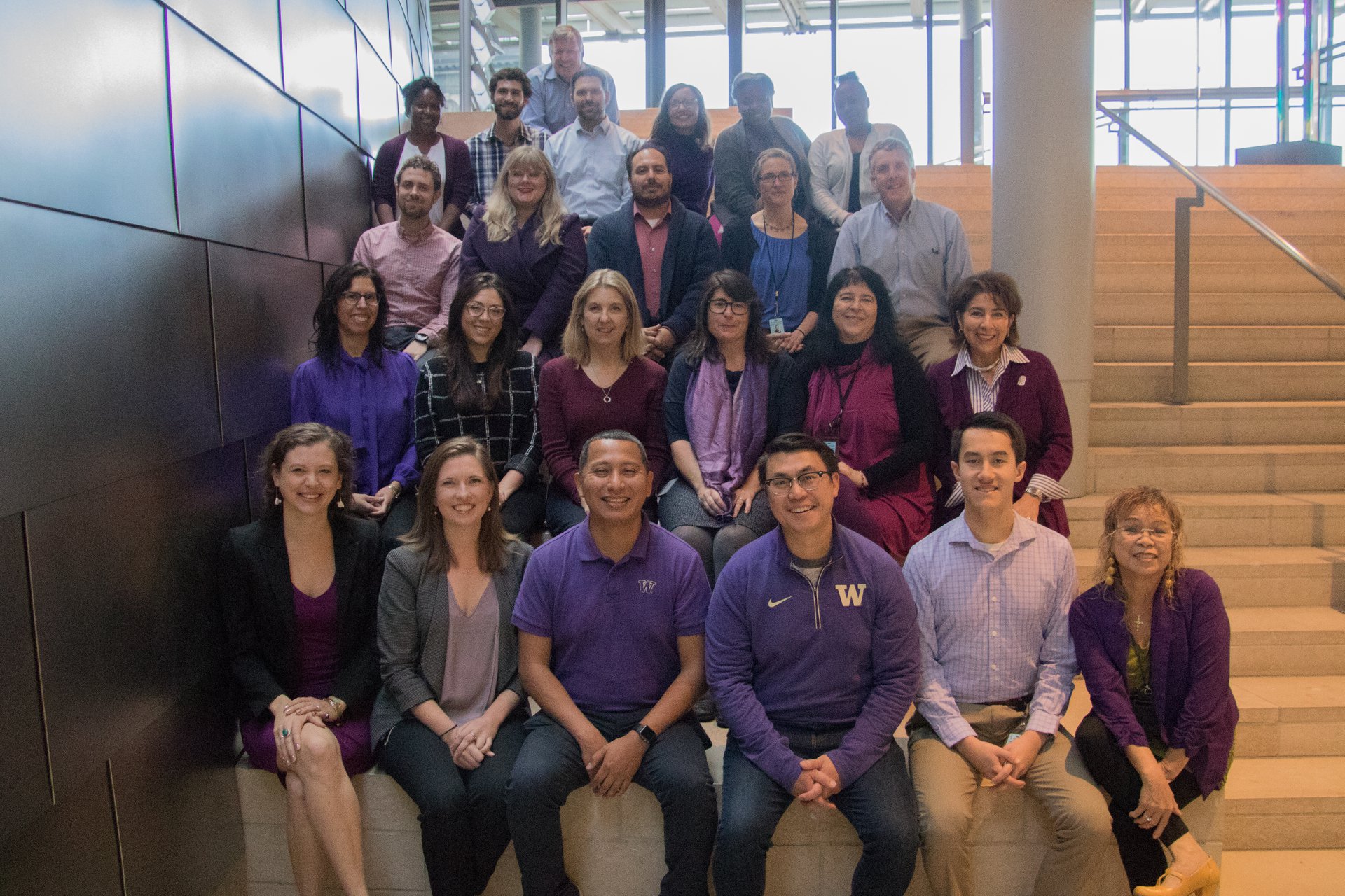 City staff gather for a photo dressed in purple for Domestic Violence Awareness Month