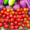 Pile of bright red cherry tomatoes and beets