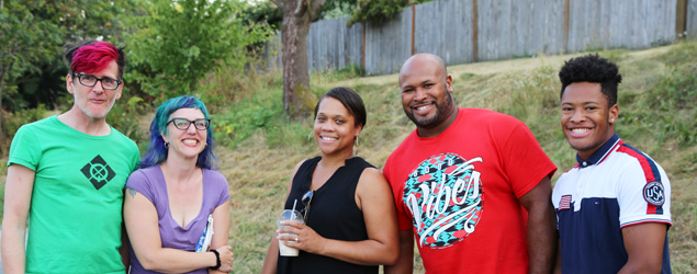 Group of people smiling at a block party.